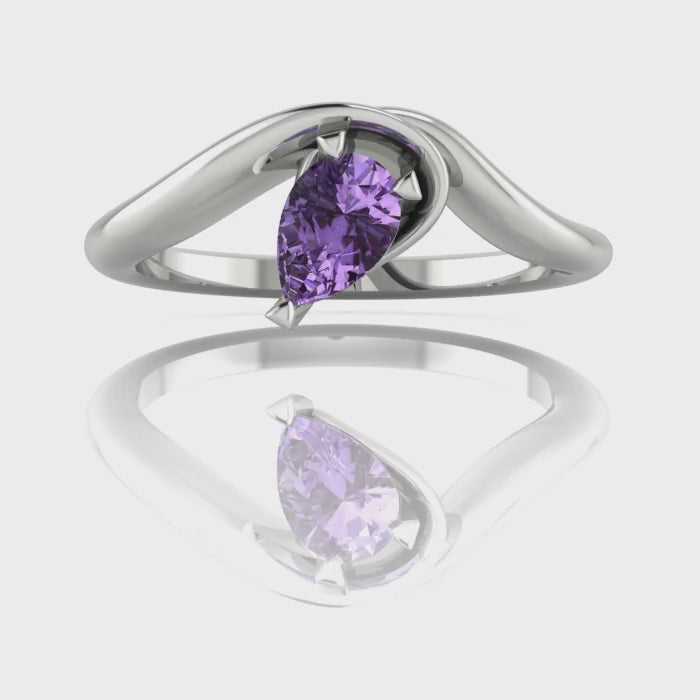 Enchanted pear shaped violet sapphire asymmetric solitaire engagement ring in white gold, rotating 360 view showing sculptural band and ethereal lavender stone