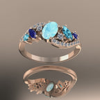 Video of the Atlantis Storm ring in 18ct rose gold, showing the contrast between the warm metal and the cool blue aquamarine and sapphires.