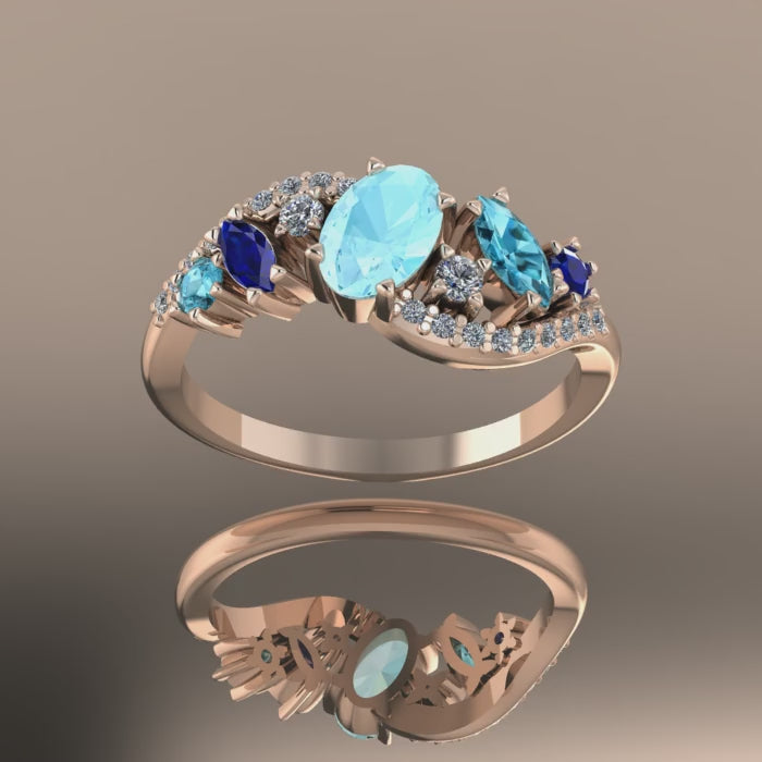 Video of the Atlantis Storm ring in 18ct rose gold, showing the contrast between the warm metal and the cool blue aquamarine and sapphires.