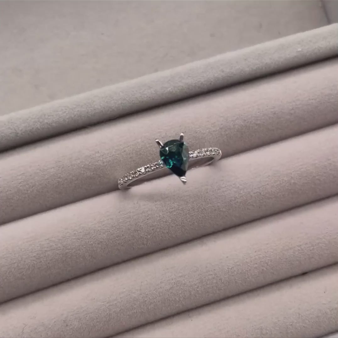 Calista pear shaped teal sapphire and diamond engagement ring in 18ct white gold, rotating 360° studio video showing the vivid teal sapphire and diamond shoulders, handmade in our London studio