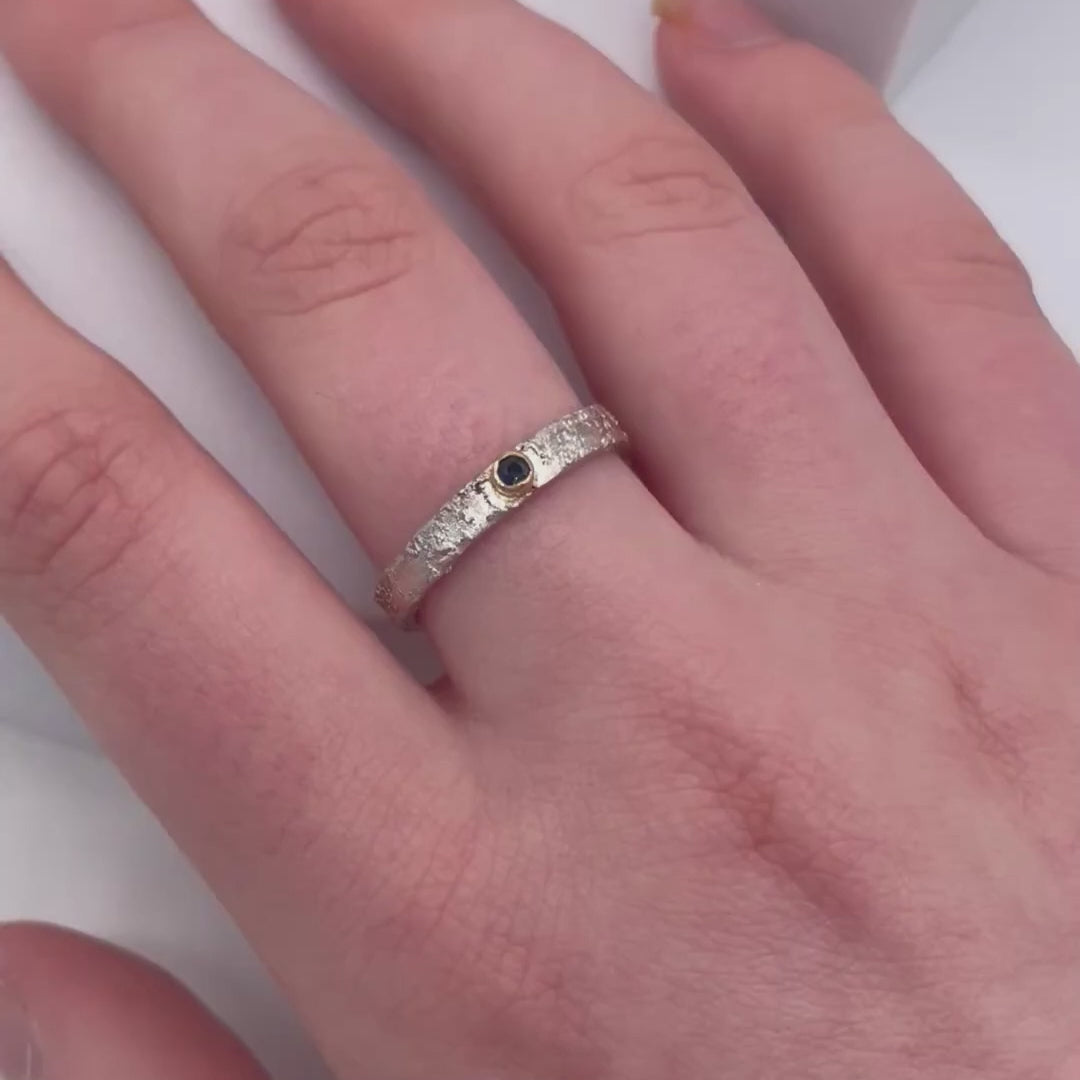 Rivda blue sapphire ring worn on hand showing organic silver texture and stone colour
