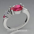Pear shaped ruby, diamond and ruby accent asymmetrical Comet engagement ring in 18ct white gold, 360 degree view