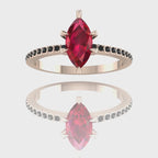 A 360-degree video of the Amoret ruby ring in 18ct rose gold. The footage showcases the rich red hues of the marquise ruby contrasted against the unconventional sparkle of the black diamond shoulders as the ring rotates.