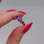 Video of the Atlantis Paradise asymmetrical cluster ring in 18ct recycled rose gold, featuring violet, pink and blue sapphires with rubies — handmade in London by Nude Jewellery