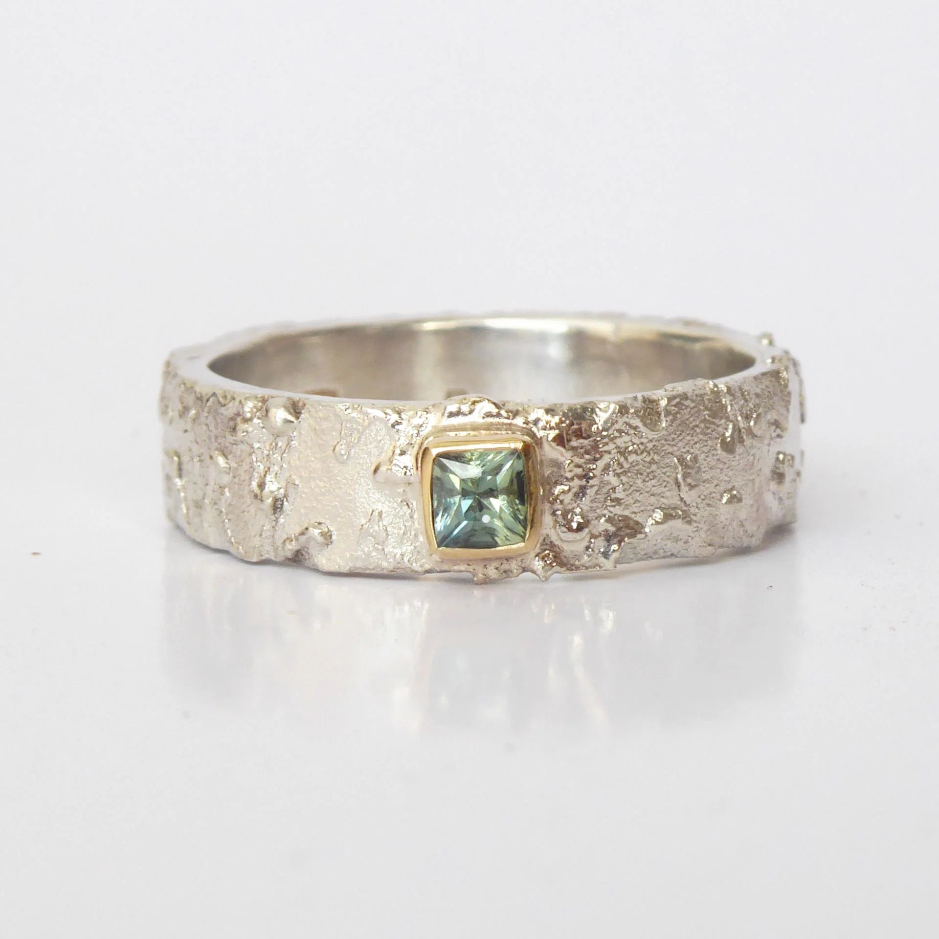Rivda princess-cut pale blue sapphire ring in sterling silver with 9ct gold setting on white background — front view