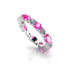 An alternate studio view of the pink sapphire and diamond eternity ring in 18ct white gold, showing the rhythmic pattern of the marquise and brilliant-cut gemstones.