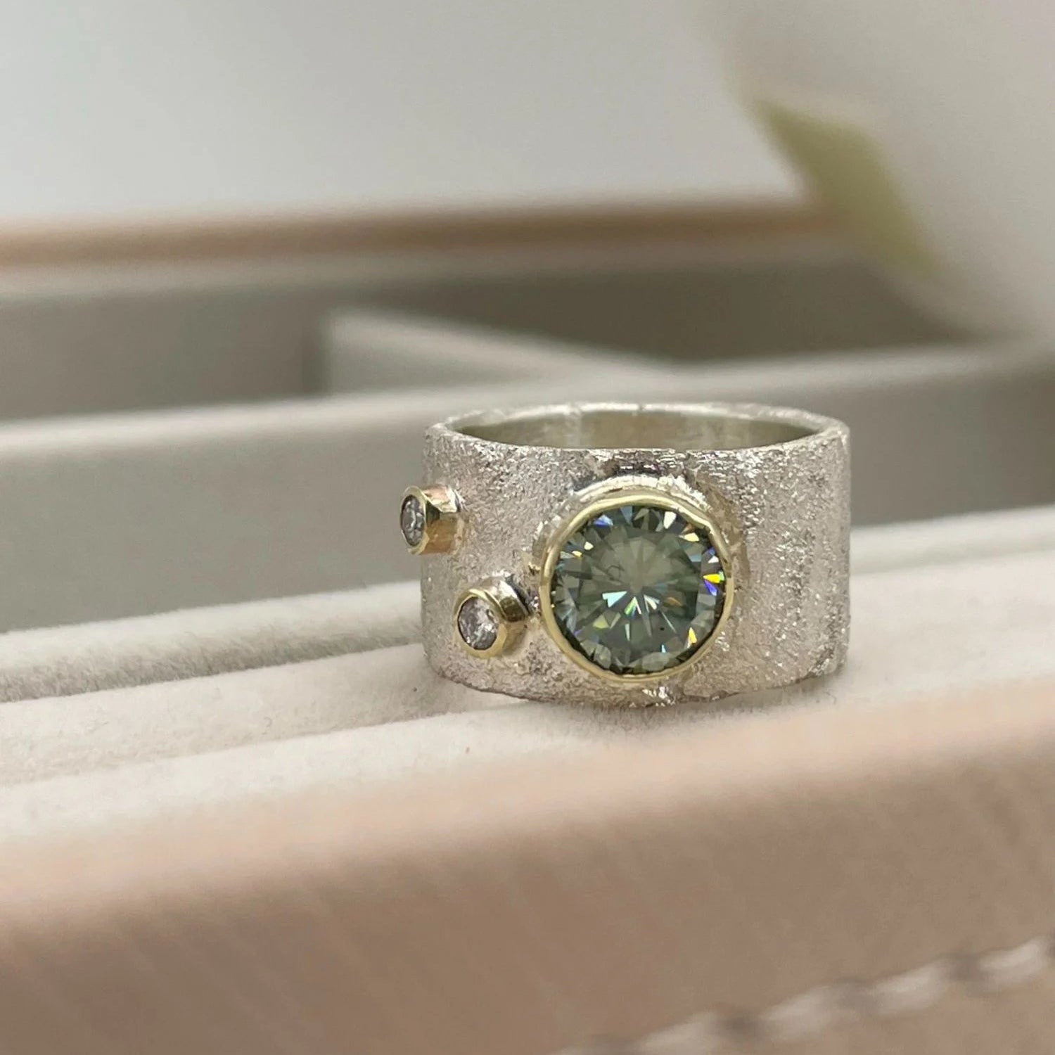 Rivda moissanite and diamond ring in sterling silver with 9ct gold setting — front view close up on tray