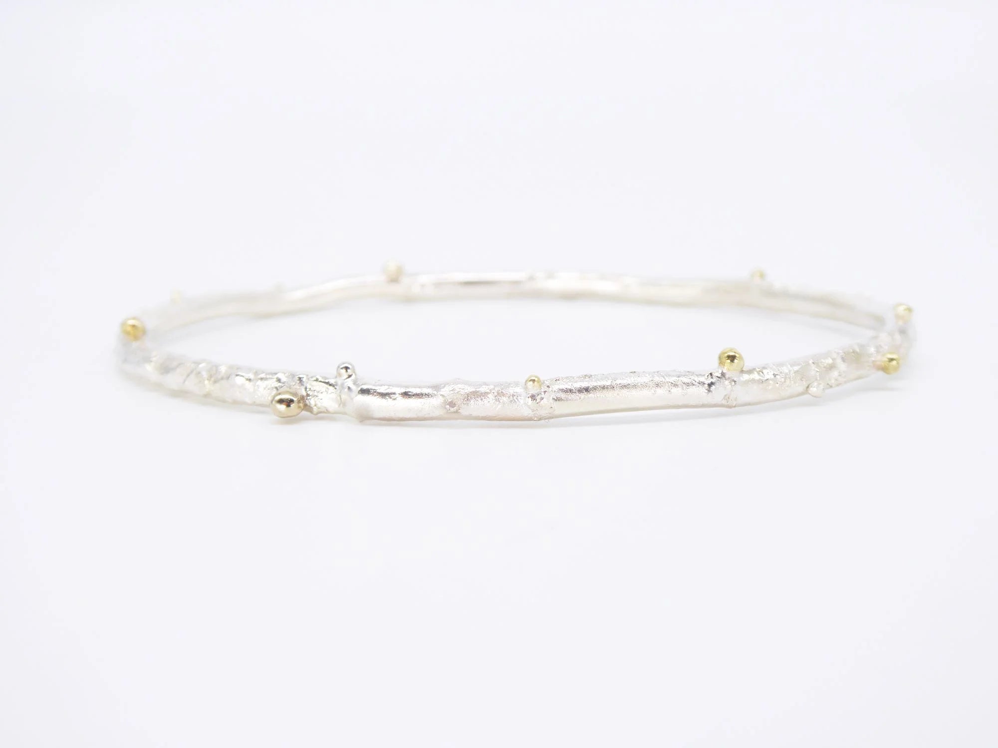 Rivda organic textured sterling silver bangle with 9ct gold bead details — handmade.