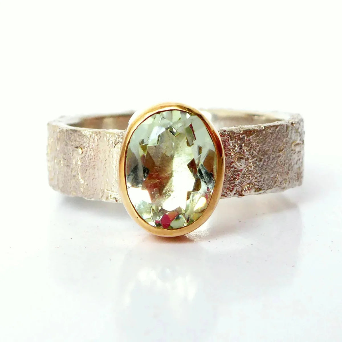 Rivda oval prasiolite ring close-up showing organic silver texture and gold setting detail