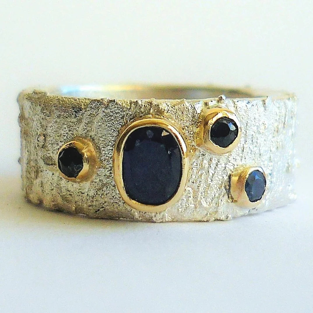 Rivda scattered sapphire ring in sterling silver with 9ct gold settings on white background — front view 
