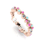 Front three-quarter studio view of the rose gold bubble band, highlighting the modern, fluid arrangement of flush-set diamonds and pastel gemstones.