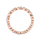 Through-finger view of the 18ct rose gold eternity ring, showcasing the smooth, polished interior under-gallery and the clean, secure settings.