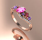 Angled image of the wave-inspired rose gold setting, highlighting the cluster of rubies, sapphires, and brilliant-cut diamonds.