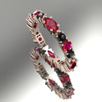 18ct rose gold eternity ring featuring alternating marquise rubies and black diamonds held in a delicate claw setting.