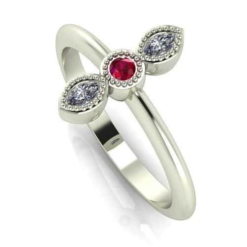 Angled view of an 18ct white gold trilogy ring with a ruby and diamonds featuring fine milgrain textured edges.