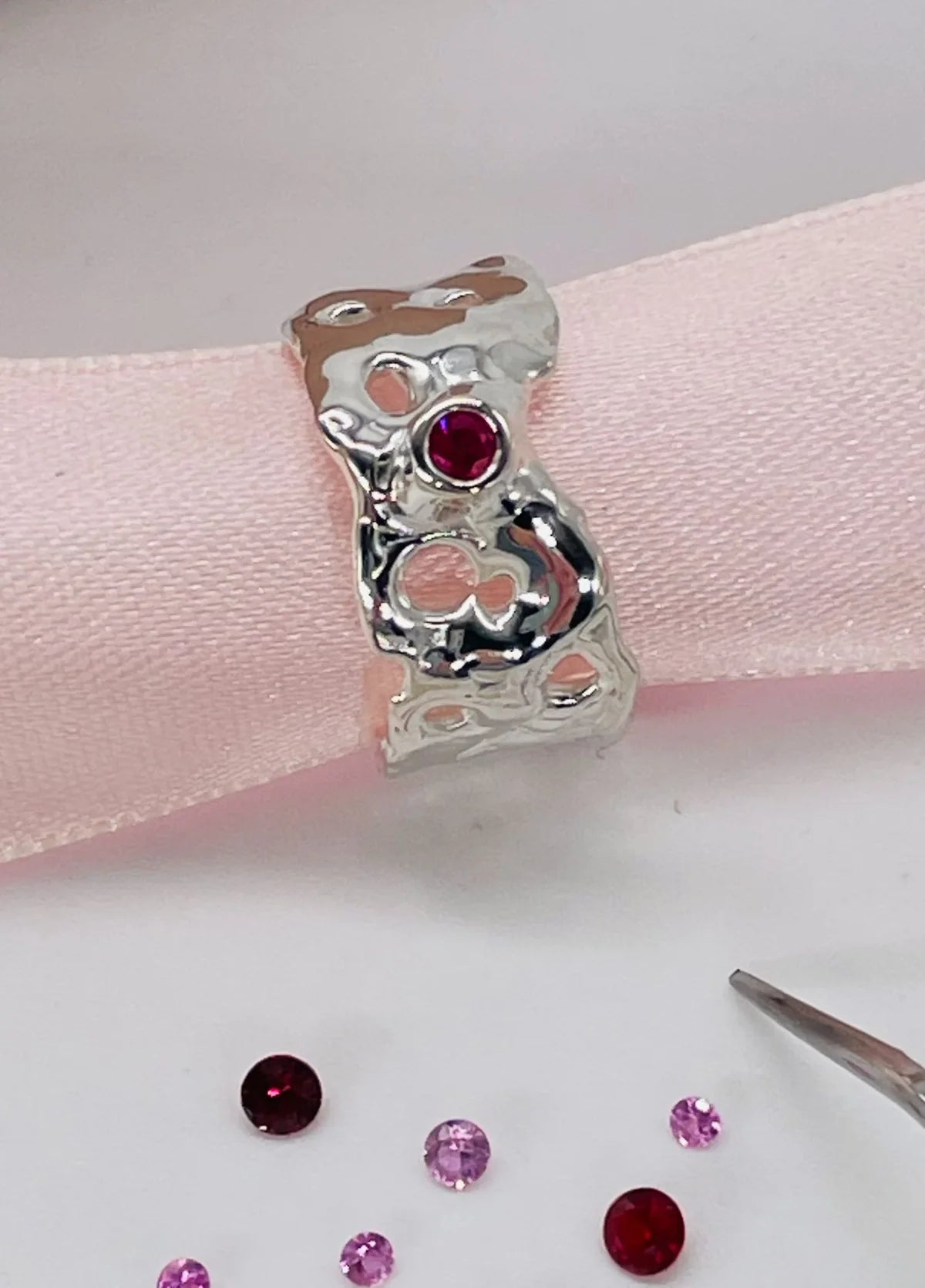 Origin Honeycomb Ring in sterling silver with a brilliant-cut ruby, showing its organic open-weave design