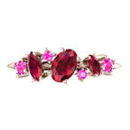 Front-facing view of the 18ct rose gold Atlantis Paradise ring featuring an asymmetrical cluster of vibrant red rubies and a pink sapphire.