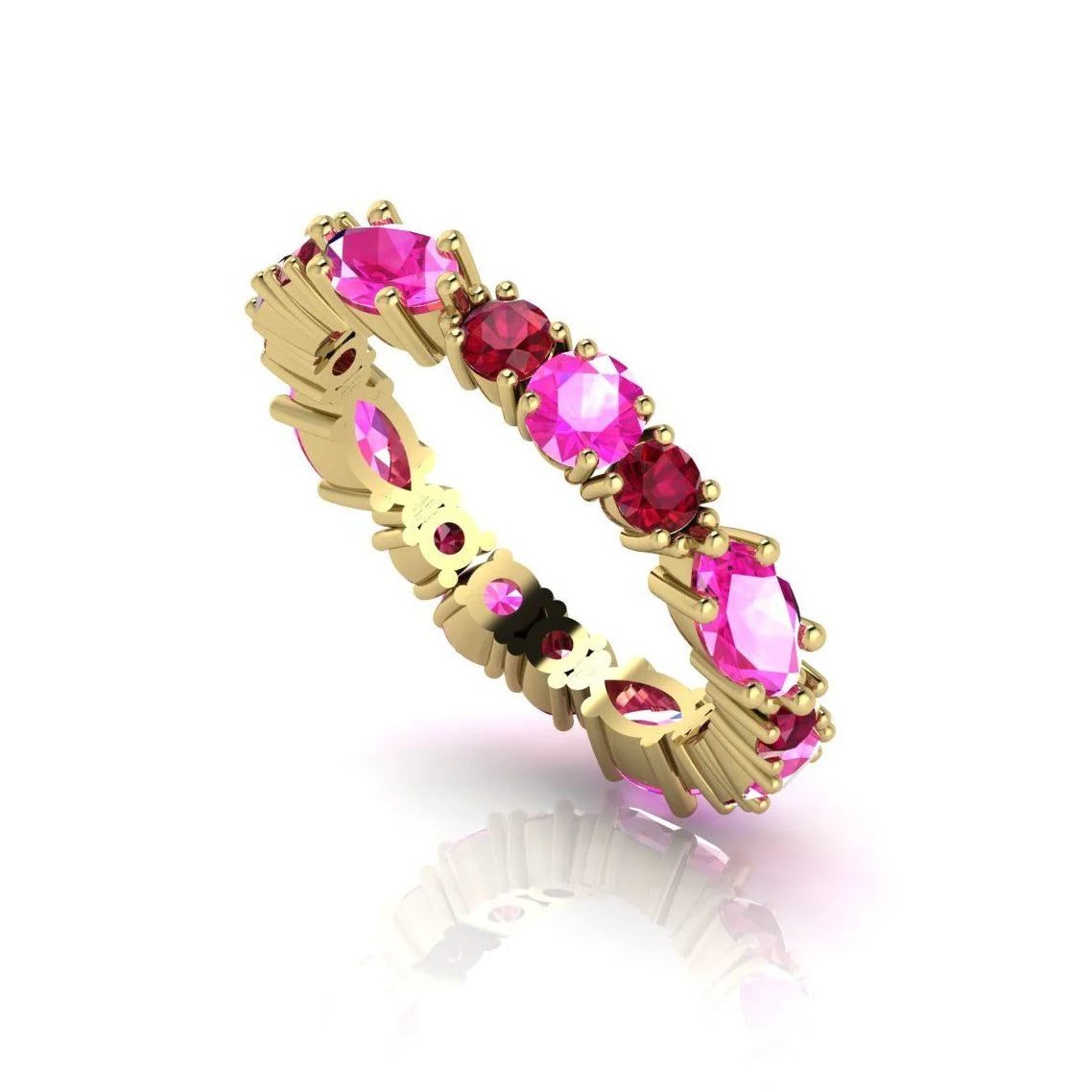 An alternative angle of the 18ct yellow gold eternity ring, showcasing the vibrant red rubies and pink sapphires in their protective claw settings.