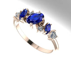 An angled perspective of the Atlantis Paradise ring, showing the offset sapphire and diamond cluster.