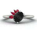 Selene black diamond and ruby engagement ring in white gold front view showing asymmetric pear ruby cluster setting