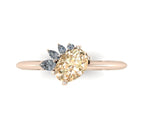 High angle studio detail shot of the Selene alternative engagement ring, showcasing the deep golden tones and exceptional light reflection across the champagne and white diamond facets.
