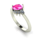 Selene oval pink sapphire and diamond engagement ring in white gold three-quarter view showing diamond cluster detail and polished band