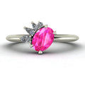 Selene oval pink sapphire and diamond engagement ring in white gold front view showing asymmetric pear and round diamond cluster