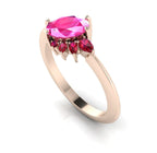 Front three-quarter studio view of the Selene pink sapphire and ruby ring, highlighting the unique, multi-coloured gemstone cluster layout against the warm rose gold shoulders.