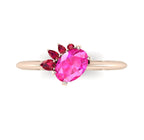 High angle studio detail shot of the Selene alternative engagement ring, showcasing the rich colour depth and light reflection across the pink sapphire and red ruby facets.