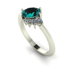 Selene oval teal sapphire and diamond asymmetric cluster engagement ring in 18ct white gold or platinum, three-quarter view showing the diamond cluster detail and polished band, handmade in our London studio
