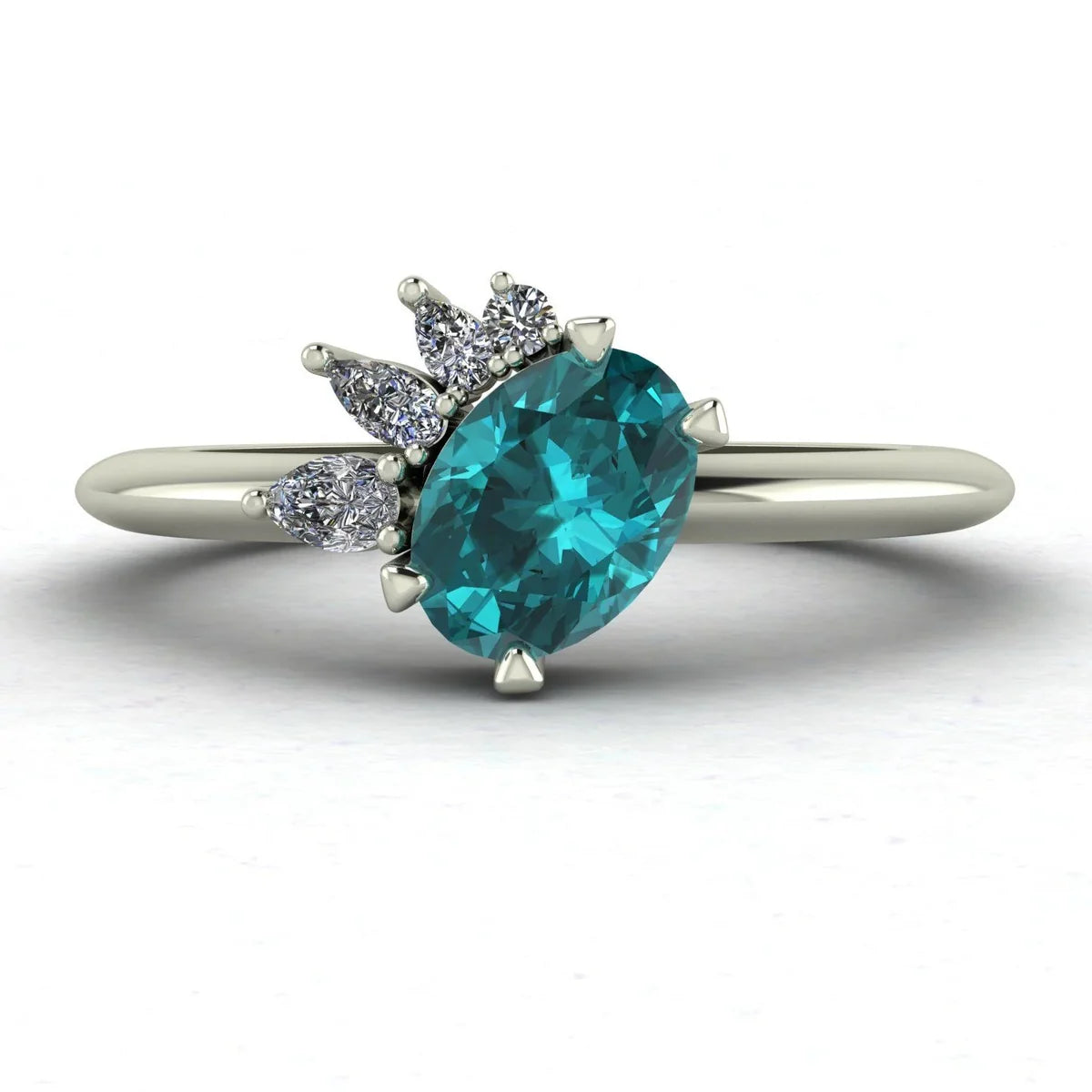 Selene oval teal sapphire and diamond asymmetric cluster engagement ring in 18ct white gold or platinum, front view showing the vivid teal sapphire and asymmetric pear and round diamond cluster, handmade in our London studio