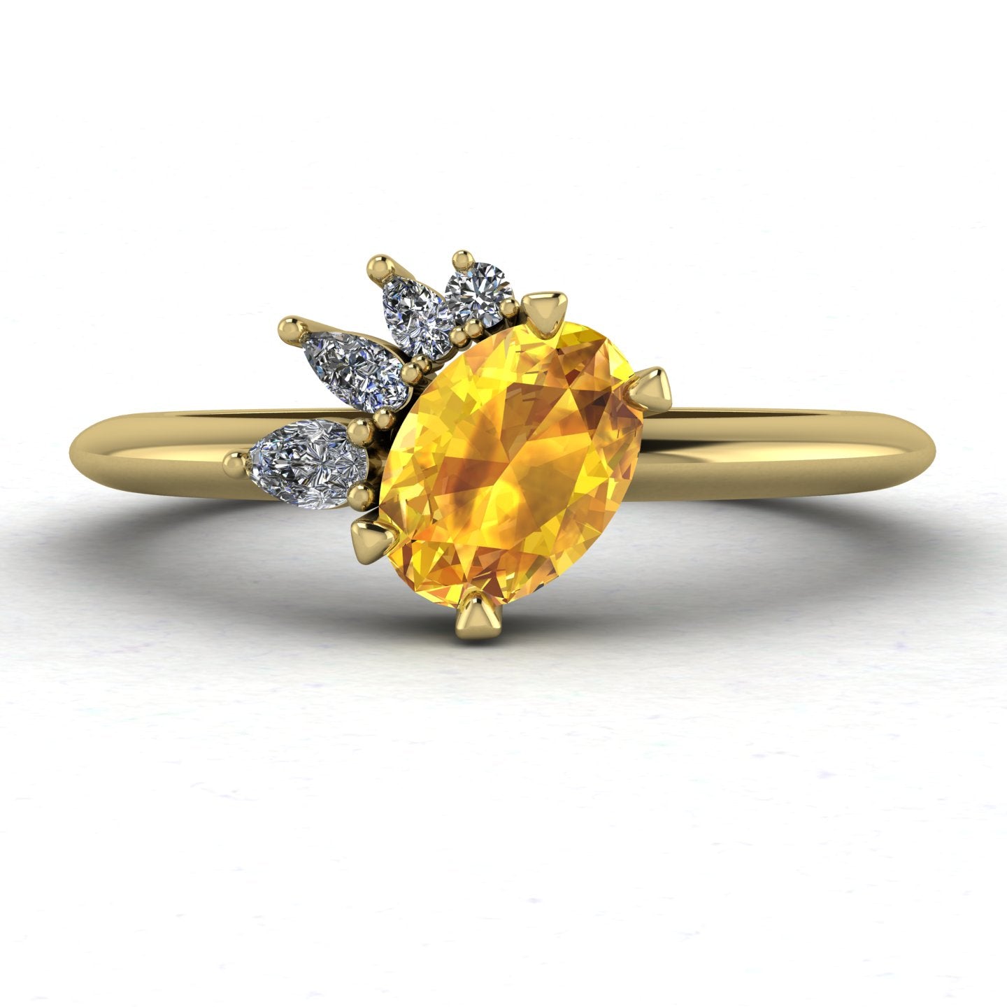 Selene cluster engagement ring, showcasing a bright oval yellow sapphire nestled within an asymmetric arrangement of white diamonds on a yellow gold band.