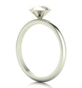 Angled perspective of a solid silver rock solitaire ring with geometric facets.