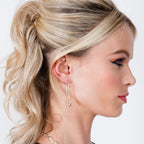 Silver Drip Earring worn on model with blonde updo — sterling silver droplet hook earring shown in profile