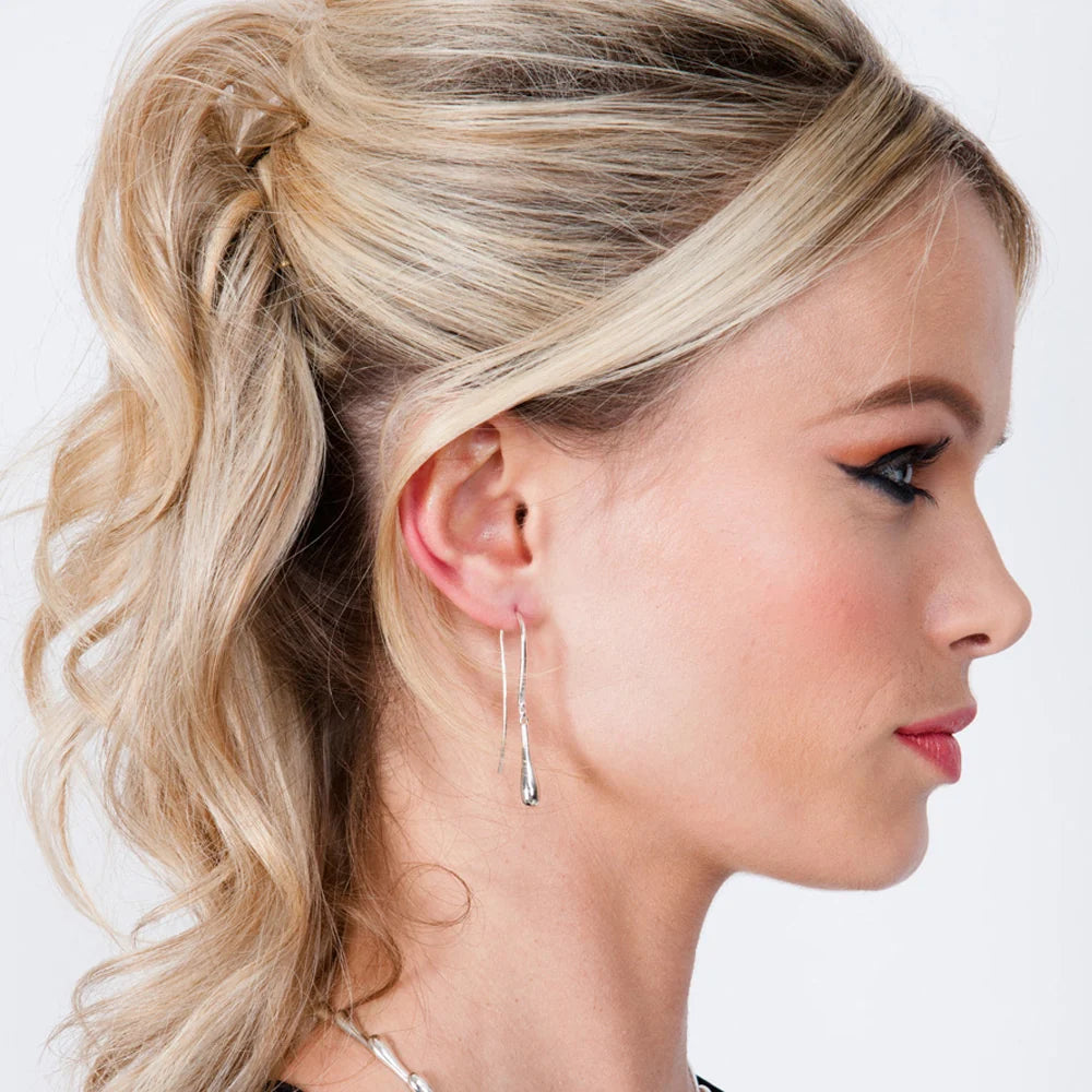 Silver Drip Earring worn on model with blonde updo — sterling silver droplet hook earring shown in profile