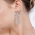 Model view of handmade silver falling earrings showing the movement of the chain and droplets.