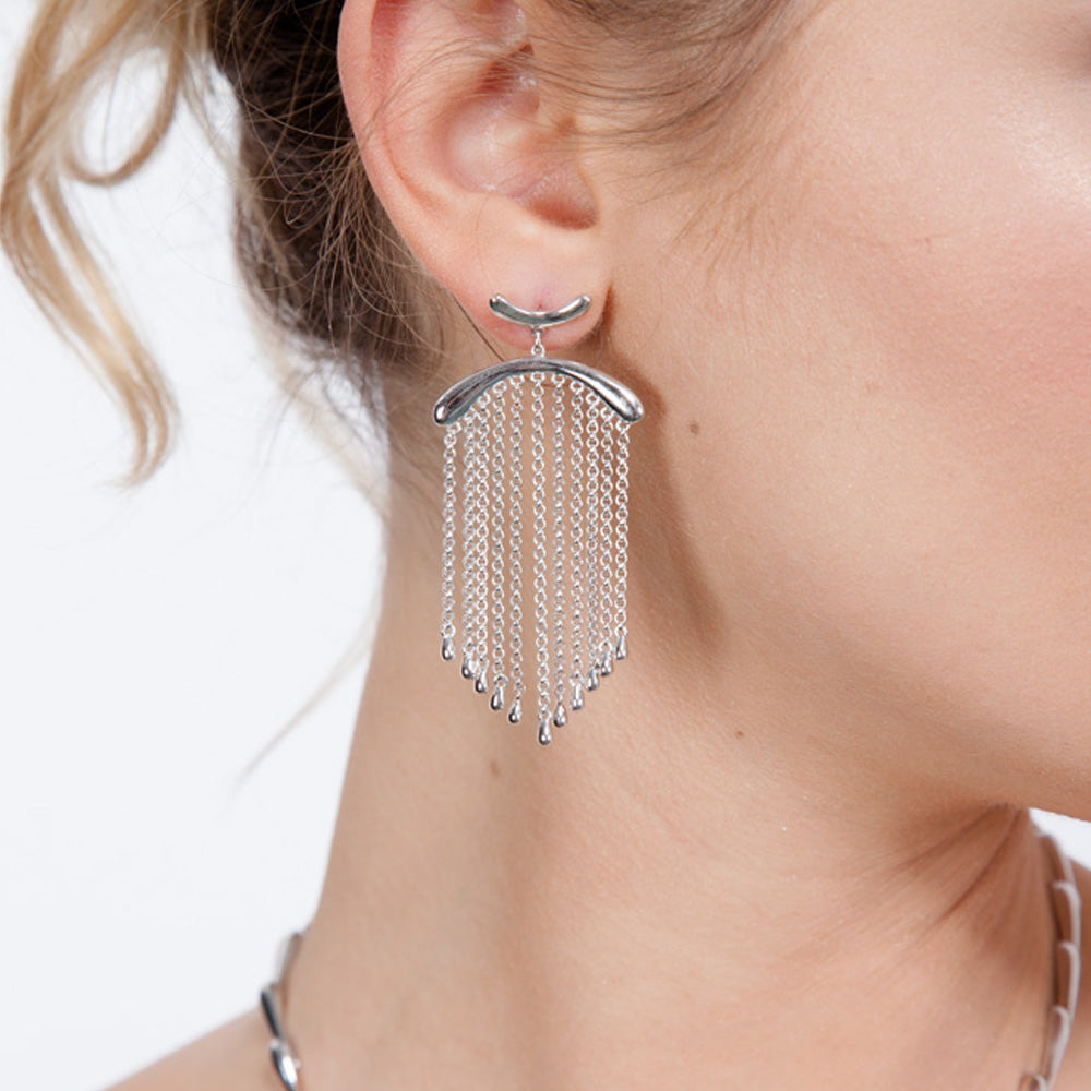 Front view of handmade silver falling earrings showing the movement of the chain and droplets.
