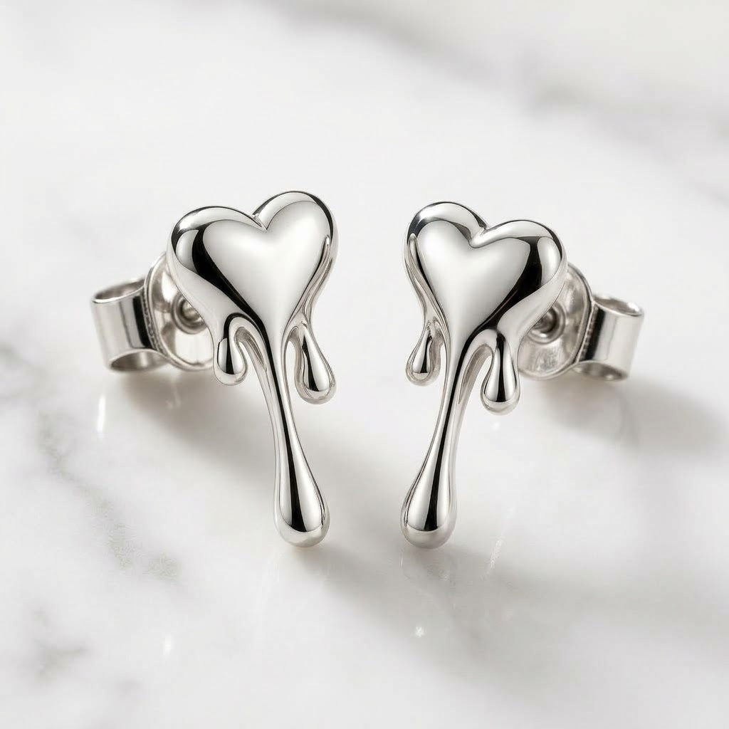 Pair of silver melting heart earrings with polished hearts and three trailing drip details.