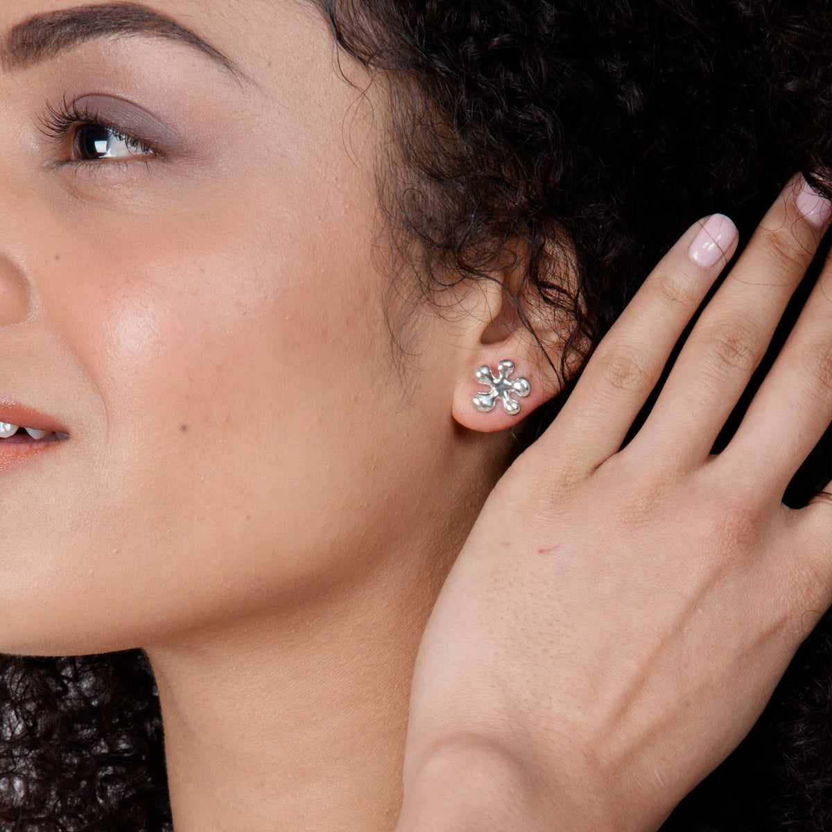 Model wearing polished 925 sterling silver Splat drop earrings, showing their scale and fluid organic design