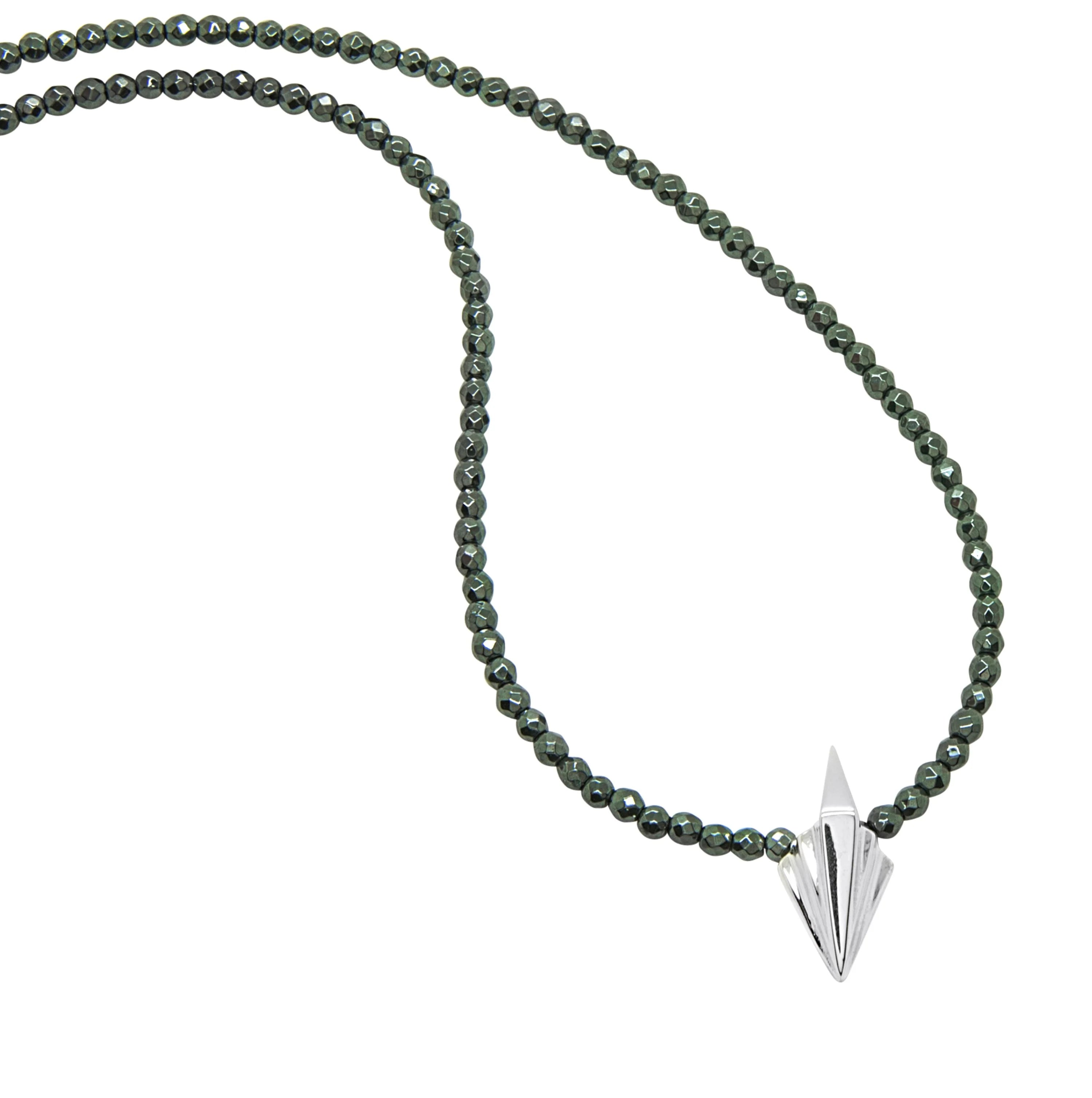 Small Art Deco sterling silver geometric pendant on full faceted hematite bead necklace, flatlay on white background