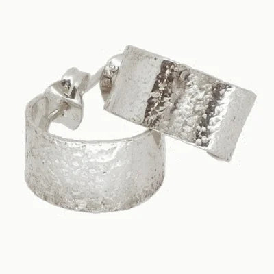 Silver textured hoop earrings on a white background