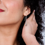 Solid Drop silver earring shown in side profile, highlighting the sculptural droplet shape