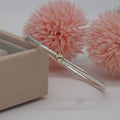 Silver bangle with a gold on a pink floral background