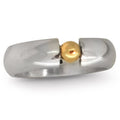 An angled perspective of the Solis Signature ring, highlighting the chunky profile of the silver band and the three-dimensional detail of the gold orbs.