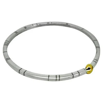 A top-down view of the Solis square bangle, featuring a 3mm square-profile recycled silver band with a single, central 9ct gold sphere.