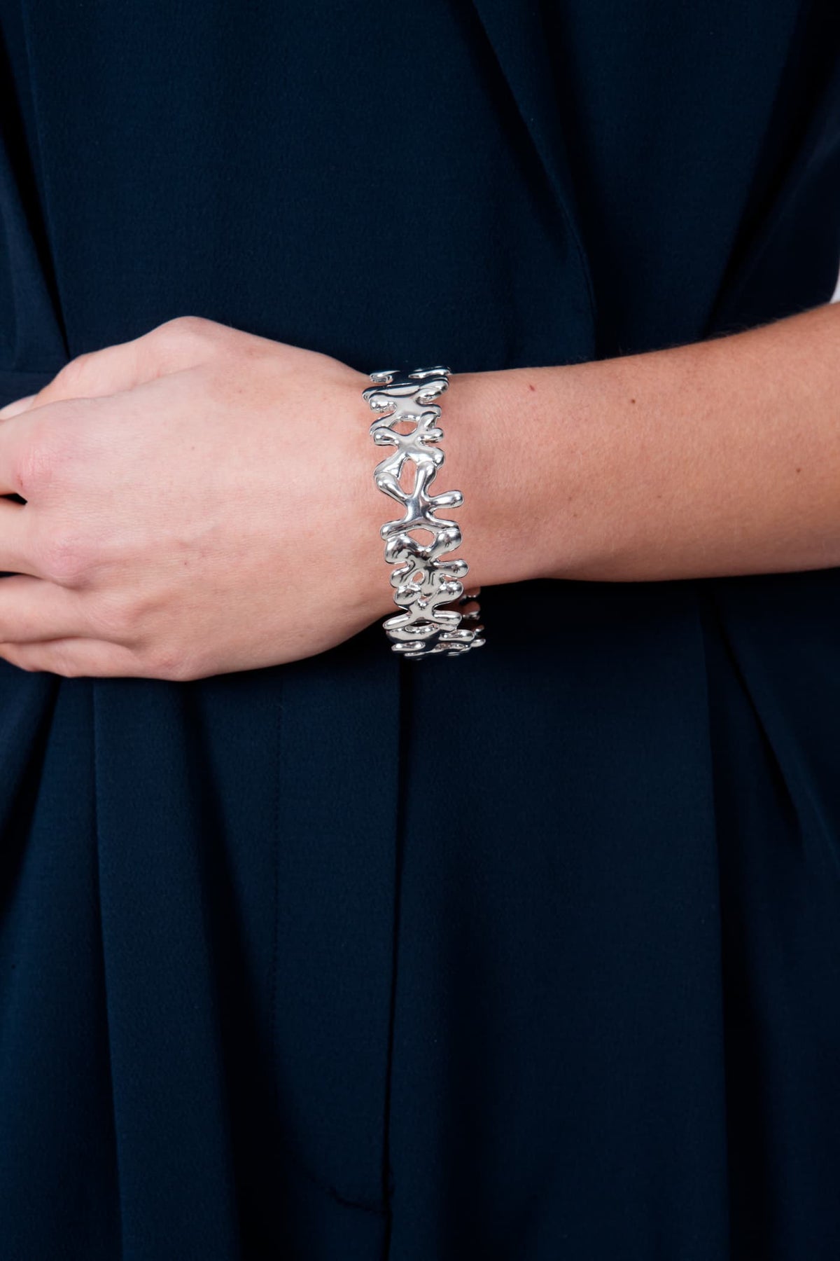 Lucy Q Splash bangle in polished 925 sterling silver worn on the wrist