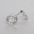 Angled view of sterling silver Vanilla earrings showing the handmade textured finish. Front and side view.