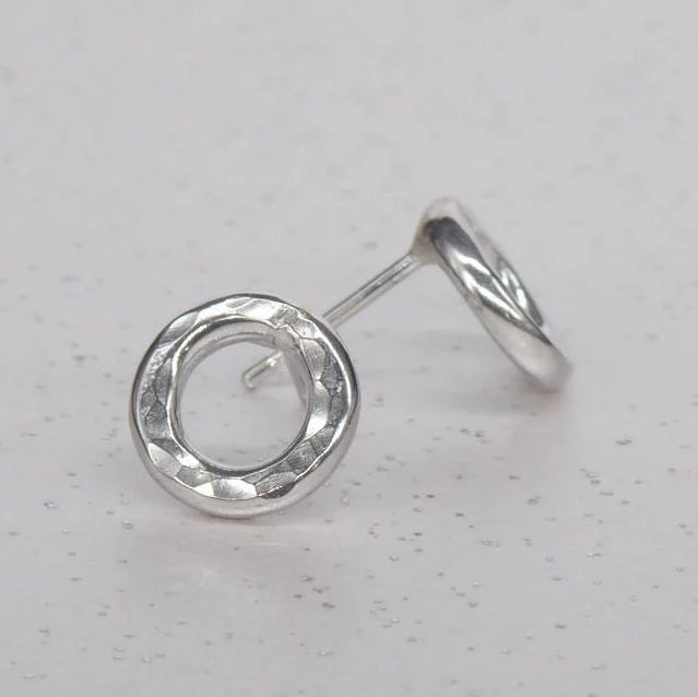 Angled view of sterling silver Vanilla earrings showing the handmade textured finish. Front and side view.
