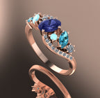Angle view of the 18ct rose gold Atlantis Storm ring, highlighting the organic wave setting and the tanzanite cluster arrangement.