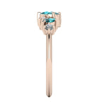Side profile of the rose gold Atlantis Paradise ring showing the depth of the diamond and sapphire settings with a polished band.